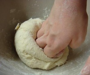 Pizza dough being kneaded