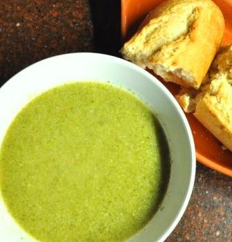 Bowl of homemade broccoli soup and fresh bread