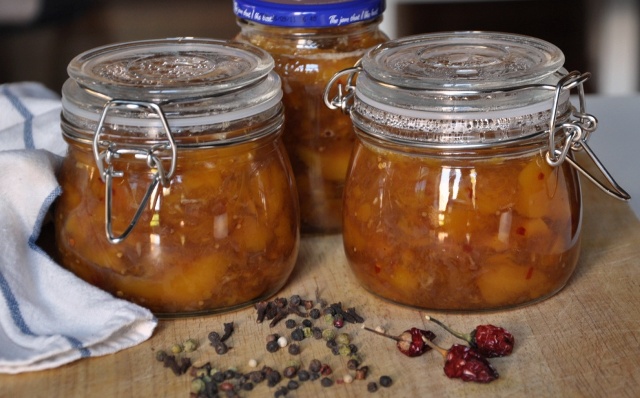 An image of 3 jars of fresh mango chutney with peppercorns