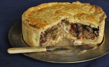 An image of turkey and bacon pie on a metal platter