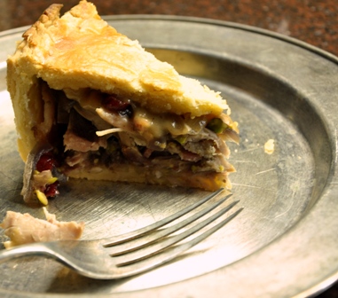 An image of a slice of turkey and bacon pie