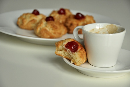 An image of Amygdalota cakes and a cup of espresso coffee