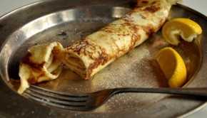 An image of pancakes with sugar and lemon