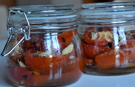 An image of roasted tomatoes in jars