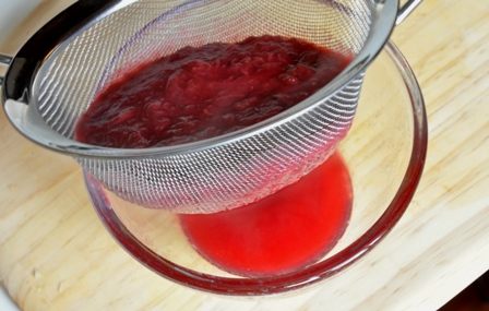 An image of rhubarb pulp being strained