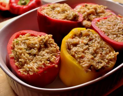 An image Greek style stuffed peppers ready to be roasted.