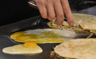 An image of cooking an egg on a hotplate.