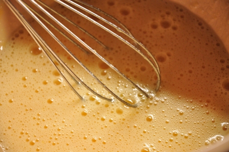 An image of eggs and sugar being whisked