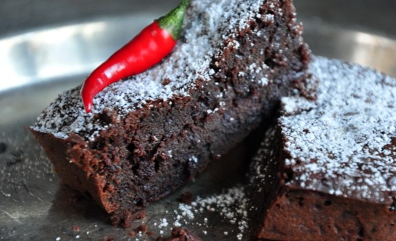 An image of beetroot and chilli chcolate brownies on a metal plate