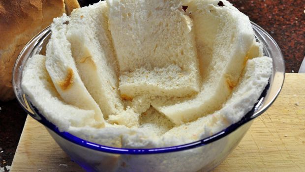 An image of a bowl lined with bread for summer pudding