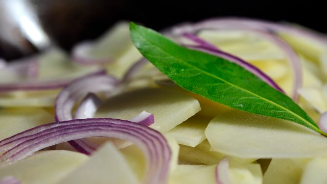 An image of potato and onion in the pan