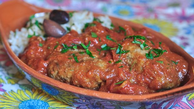 An image of Soutsoukakia - Greek meatballs with rice and tomato sauce