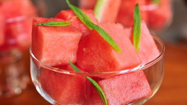 An image of watermelon and mint salad in a glass bowl