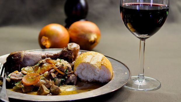 Coq au Vin with a glass of red wine