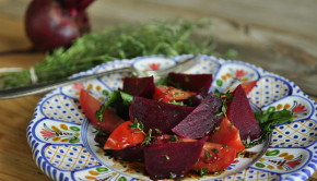 Beetroot and tomato salad on a plate with thyme