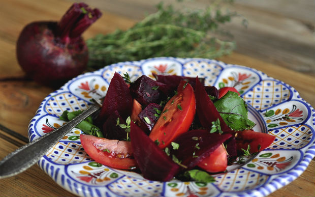Detox salad with beetroot tomatoes and thyme on a Spanish plate