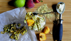 Coconut ice cream with pistachio praline and peaches on a board