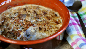 Baked rice pudding with cinnamon in earthenware bowl