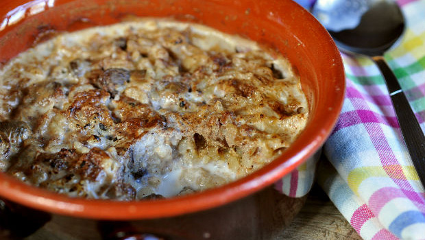 Baked rice pudding with cinnamon in earthenware bowl