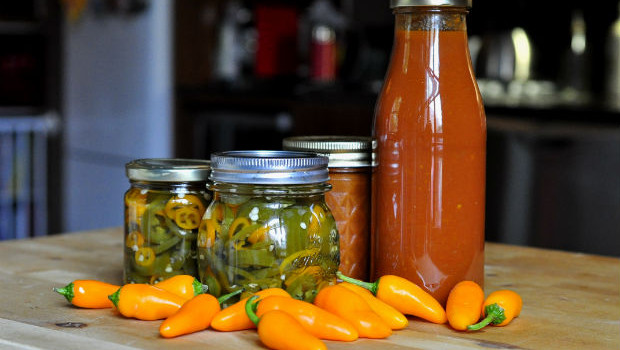 pickled chilli and hot chilli sauce on table