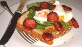 Sauteed chorizo sausage and poached eggs on toast with spinach