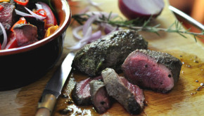 Anti-oxidant salad with freshly cooked kangaroo steak on a board
